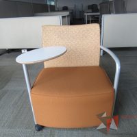 Lote 0055 - 2 Sillones Herman Miller Celeste con paleta, 2 ruedas, descansa brazos, asiento y respaldo en tela color naranja