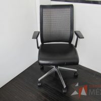 Lote 036 - Silla operativa con ruedas, descansabrazos, asiento tipo piel y respaldo en malla color negro - Imagen 3